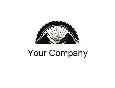 sun's rays forming a wheel behind mountains for a mountain biking logo